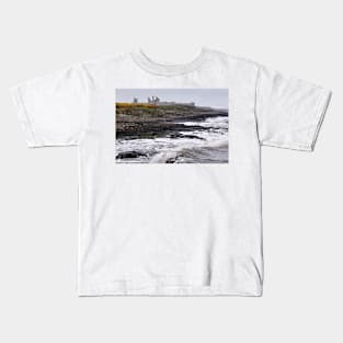 Waves battering the coast near Dustanburgh castle Northumberland, UK Kids T-Shirt